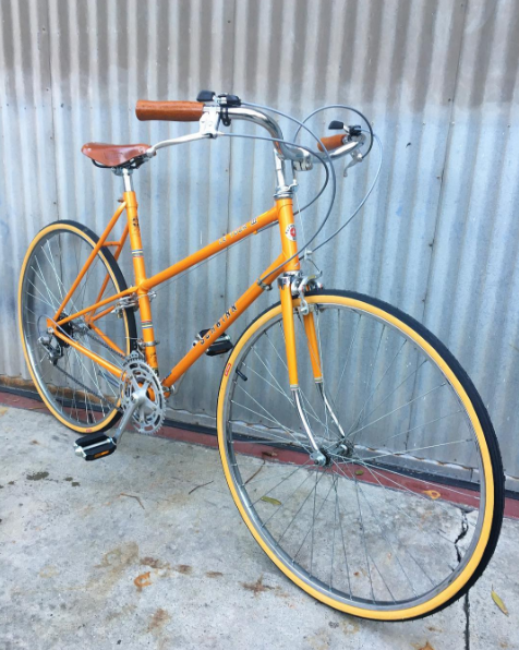 Schwinn Le Tour Step-Through Mixte Style City Bike in Miracle Tangerine Mango Color